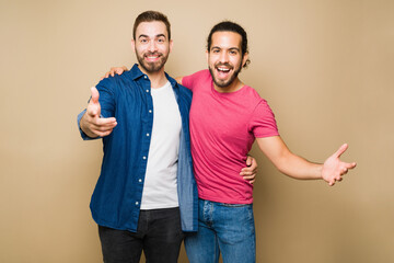 Cheerful attractive man and his gay partner hugging and celebrating