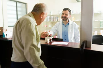 Foto op Canvas Elderly old man getting his prescription pills at the nursing home pharmacy © AntonioDiaz