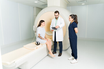 Doctor and radiologist showing the MRI test results to a female patient