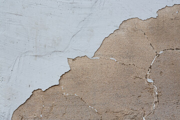 Old wall with cracked stucco. Weathered rough surface. Vintage texture great for background and design.