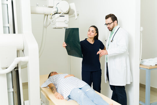 Doctor and radiologist looking at the x-ray images and test results