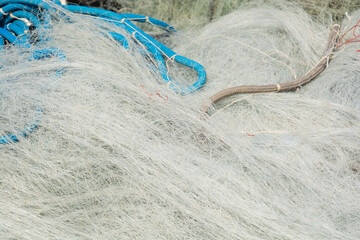 close-up of Disorderly fine mesh fishing nets in a heap after use