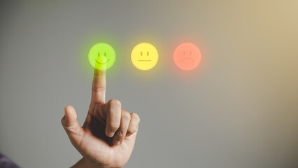 Business person are touching the virtual screen on happy Smiley face icon to give satisfaction in...
