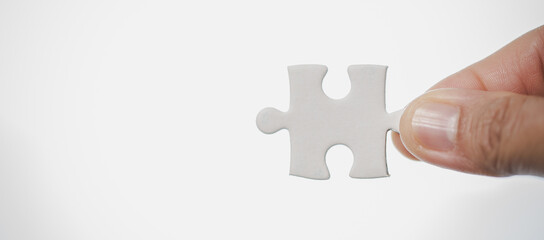 Business woman person hand holding puzzle piece idea for strategy and solution. Closeup part of two...