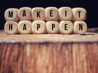 Make it happen text on wooden cubes in vintage background. Inspirational and Motivational Quote.