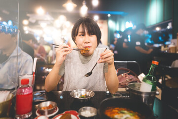 Portrait happy smile young adult asian woman holding fried chicken at Korean restaurant