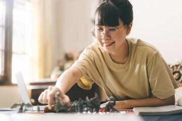 Young adult asian woman enjoying role playing tabletop and board games