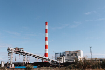 Fototapeta na wymiar Coal-fired thermal power plant with pipes