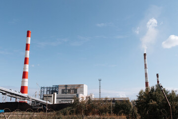 Fototapeta na wymiar Coal-fired thermal power plant with smoke from pipes