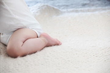 Little baby sitting on knees. baby learning sitting and standing