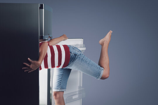 Woman With Her Head In The Fridge