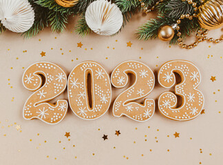 Gingerbread cookies in the form of numbers, gingerbread New Year 2023 and season festive decor on beige background