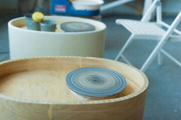 Fototapeta premium Pottery workshop in perfect order. Several potter's wheels in the workshop. High quality photo