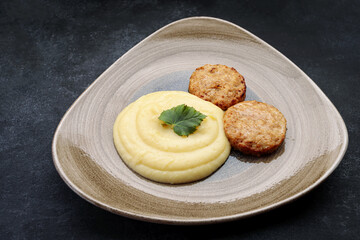 Mashed potatoes with steam cutlets and parsley