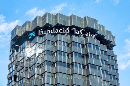 A sign reading Fundacio la Caixa is on top of a modern building.