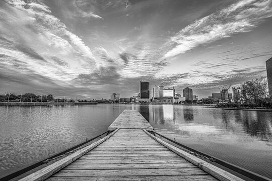 Toledo, Ohio skyline reflected in the water of the Maumee river at dawn in black and white