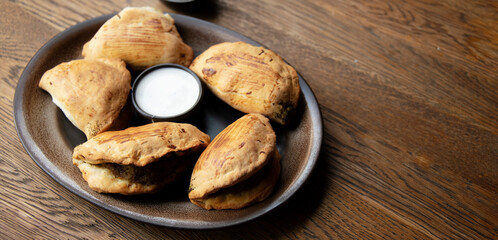 A plate of oven-baked pierogi on a restaurant table