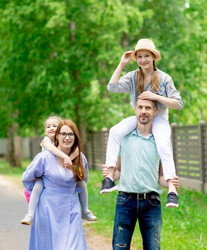 Happy family-mother,father and two children daughter little girl teen having fun outdoor