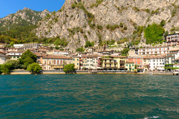 The beautiful Garda lake in Italy, seen from onboard a tourist ferry. It is a beautiful summer day, with just a little bit of clouds.