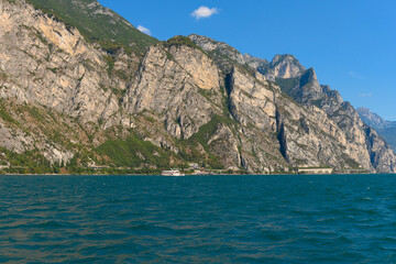 Sailing past tourist ferry on the beautiful lake Garda in Italy. It’s a beautiful, sunny summer day, sailing on lake Garda, and passing one of the many tourist ferries sailing the lake.