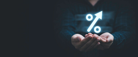 Businessman holding glowing percentage sign symbol for financial planing and interest rate growth...