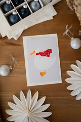 A cute postcard with a goose is on the table