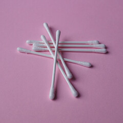 cotton swabs on the pink background, cosmetics and hygiene