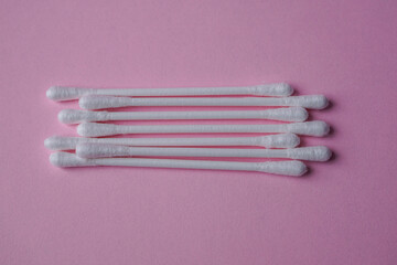 cotton swabs on the pink background, cosmetics and hygiene