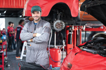 car service, repair, maintenance concept - Arab auto mechanic man or Smith stand beside a car at workshop warehouse before start checking a car in the garage for maintenance services