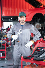 car service concept , repair, maintenance concept - Arab auto mechanic man or Smith stand beside a car at workshop warehouse before start checking a car in the garage for maintenance services