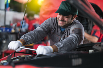 car service, repair, maintenance concept - Arab auto mechanic man or Smith Checking/repair machine at workshop warehouse, technician doing the checklist for repair machine a car in the garage