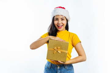 Attractive excited asian woman wear Santa Clause christmas hat and holding new year gift box, isolated on background.
