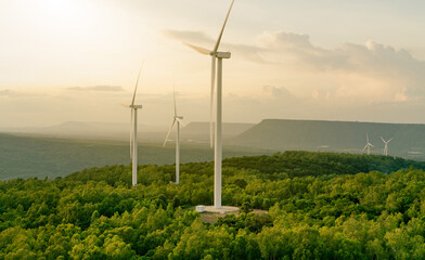 Fototapeta Wind energy. Wind power. Sustainable, renewable energy. Wind turbines generate electricity. Windmill farm on mountain with sunset sky. Green technology. Renewable resource. Sustainable development. obraz