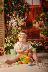 girl one year old shooting in the studio in the background flowers wooden background