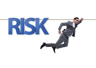 Businessman in risk concept walking on tight rope