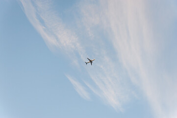 A plane is flying in the blue sky