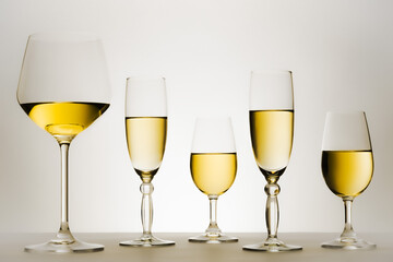 Set of glasses with white wine in series or row. 