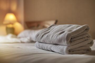 White towel on the bed decoration in bedroom interior ,White towel on the bed in the hotel room  - obrazy, fototapety, plakaty