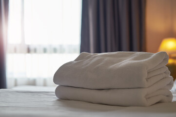 White towel on the bed decoration in bedroom interior ,White towel on the bed in the hotel room 