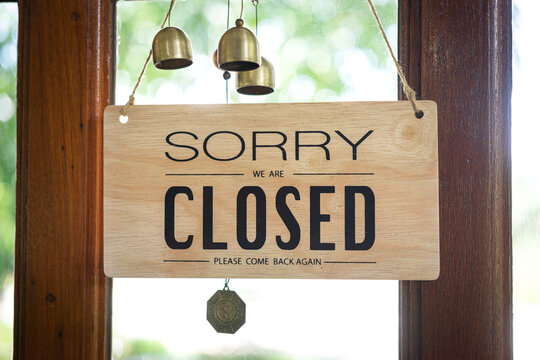 "Sorry, we are closed" wooden banner of cafe or restaurant door. Sign and symbol for business object photo.