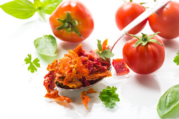 small pieces of dried tomatoes next to fresh tomatoes