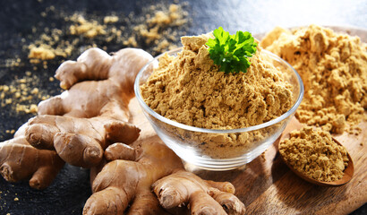 A bowl with ground ginger and its fresh rhizome