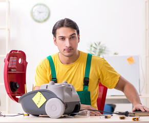 Man repairman repairing vacuum cleaner
