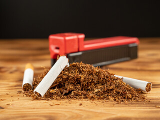 Cigarettes and tobacco on a wooden background. Smoking damages the lungs and kills.