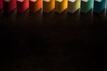 Colored wooden blocks with light coming through for the light side to dark side. Diagonally aligned...
