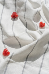 Obraz na płótnie Canvas background from linen tablecloth and red raspberry