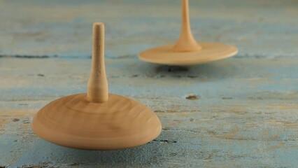Peg toy or whirligig rotates on a vintage wooden board.