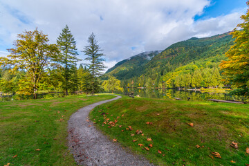 Fototapeta na wymiar Footpath along autumn lake. Fall colors in Silver Lake Campground, Fall Time, North Cascades Region