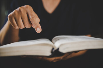 Young woman person hand holding holy bible with study at home. Adult female christian reading book in church. Girl learning religion spirituality with pray to god. concept of student education faith.