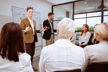 group of business men and women  are meeting together, giving opinions, discussing and exchanging ideas  by everyone cooperating and having good unity